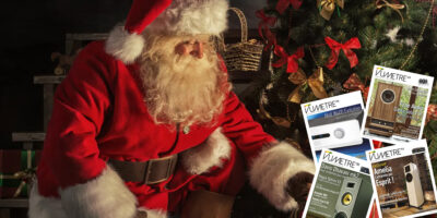 Santa Claus brought gifts for Christmas. Santa is placing gift boxes under Christmas tree